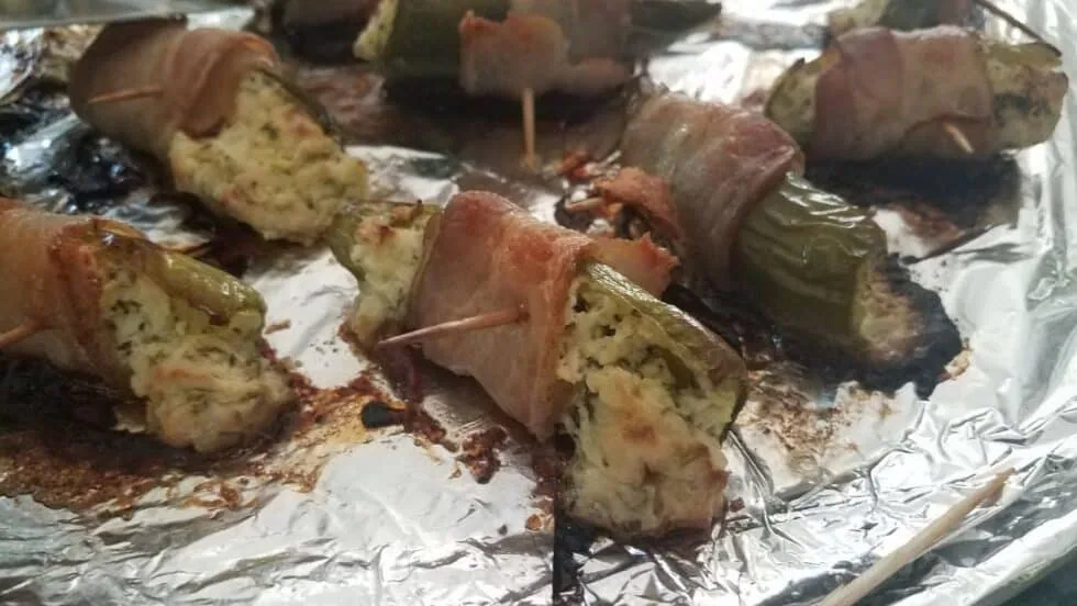 Bacon-wrapped bell pepper bites with horseradish cream cheese, arranged on a serving tray