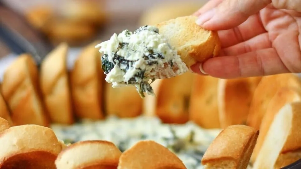 Warm feta, spinach, olive and cream cheese dip, baked until bubbly in a serving dish